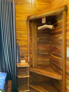 una sauna de madera con un par de zapatos. en Nana Home, Entire Amazing Wooden Chalet, en Phu Quoc