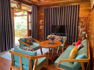 a living room with a couch and a table at Nana Home, Entire Amazing Wooden Chalet in Phu Quoc