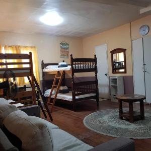 a living room with bunk beds and a couch at Old Orangewood Bed & Breakfast in Baguio