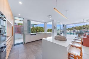 a kitchen with a counter and some windows at Pavilions 9 & Buggy - Hamilton Island in Hamilton Island