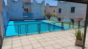 a swimming pool with two chairs and a table at Castillo Del Lago - Carlos Paz - D26 in Villa Carlos Paz