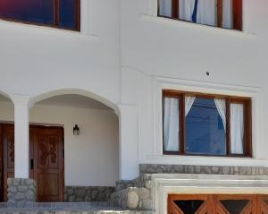 dos ventanas en el lateral de un edificio blanco en Hospedaje Lupé en Cachí