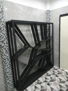 a glass shelf in a bathroom with a tiled floor at Momento Resort in Pattaya South