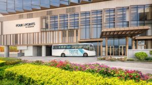 a bus parked in front of a building at Four Points by Sheraton Hong Kong, Tung Chung in Hong Kong