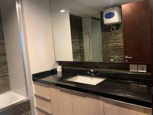a bathroom with a sink and a mirror at 2br- Central Park Residence Alaina Tower Floor 29 in Jakarta +18 photos