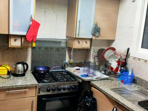 a kitchen with a stove and a sink at Private Room with private bathroom in a cozy Apt. And shared area in Cairo