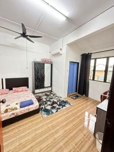 a bedroom with a bed and a ceiling fan at nd homestay in Kuala Lipis