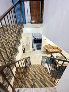 a spiral staircase in a house with a couch at nd homestay in Kuala Lipis