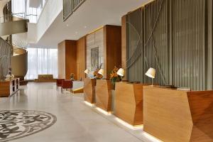 a lobby with wood paneling and a reception desk at Sheraton Astana Hotel in Astana