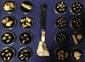 a group of black cups filled with gold and a bottle at Inglewood Motel and Caravan Park Victoria in Inglewood