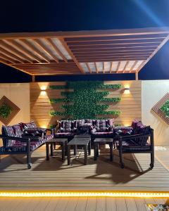a group of benches with pillows on a wall at Traveler Rooms 2 in Al Madinah