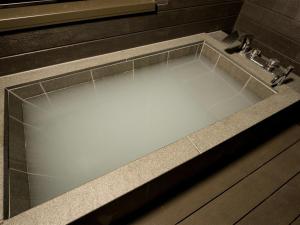 a bath tub with a sink in a bathroom at Rakuten STAY Nikko Hoden Capacity of 4 persons in Nikko