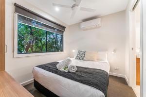 a bedroom with a large bed and a window at Tasman Holiday Parks - South Bright in Bright