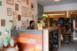 a man sitting at a counter in a restaurant at ADN Algo de Nosotros - Malaika in Medellín