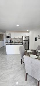 a kitchen with a table and chairs and a counter at Elegant Condo in an Upscale Building in Cabo San Lucas