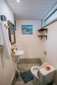 a bathroom with a toilet and a sink at Mianahere Studio Bora Bora in Bora Bora