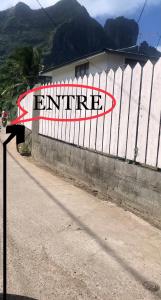 a white fence with a sign that reads entrance at Mianahere Studio Bora Bora in Bora Bora