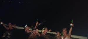 a group of people with their hands in the air at Family Hostel in Lovina