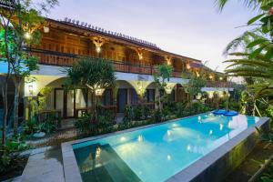 an exterior view of a house with a swimming pool at Green Bali Guest House in Munggu