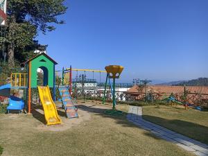 a park with a playground with a slide at Kasauli Resort by Piccadily in Kasauli
