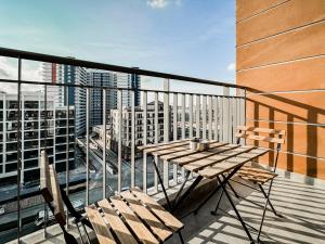 a table and chairs on a balcony with a view of a city at Perfect Studio in Arjan in Dubai