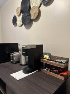 a counter with pots and pans hanging on a wall at Maiden Nest Private Master Suite in Pawtucket