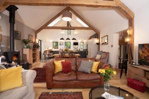 a living room with a brown leather couch at Beautiful Luxury one bedroom retreat in Far Sawrey in Far Sawrey