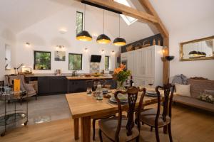 a kitchen and living room with a wooden table and chairs at Beautiful Luxury one bedroom retreat in Far Sawrey in Far Sawrey