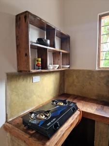 a stove sitting on a wooden table in a kitchen at Mafia Island Bungalows in Utende