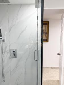 een douche met een glazen deur in een badkamer bij Tidy Private Rooms with Full Kitchen in Toronto
