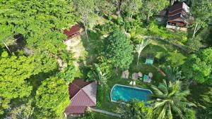 an aerial view of a house with a pool and trees at Banyan Bay Villas in Ko Jum