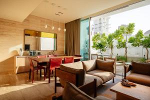 an open living room with a dining room and kitchen at The Chedi Al Bait, Sharjah in Sharjah