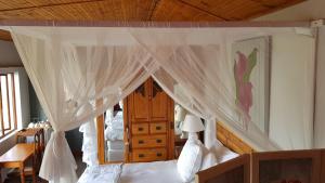 a bedroom with a bed with a canopy at The-Ark B&B in Pearly Beach
