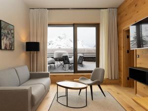 a living room with a couch and a table at Apartment in Schröcken near Ski Arlberg in Schröcken