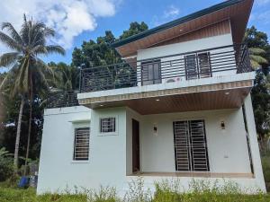 a house with a balcony on top of it at Chateau d' sentier in Davao City