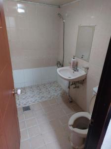 a bathroom with a toilet and a sink at Mokhwajang Motel in Goyang