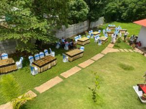 a group of tables and chairs in a yard at Greenhouse Homestay in Siddapur
