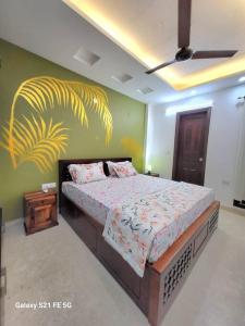 a bedroom with a bed and a painting on the wall at BnBBuddy Athulyam 3 BHK Homestay, Shalimar Bagh in New Delhi