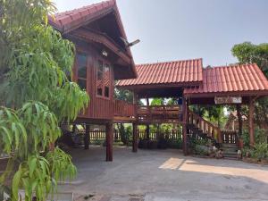a tree house with a deck and a porch at Duangmanee home stay 