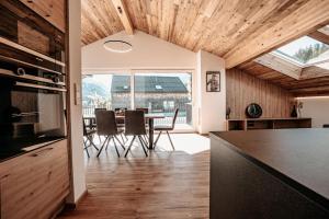 a kitchen and dining room with a table and chairs at Tanners Chalet Apartments in Altenmarkt im Pongau
