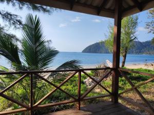 a view of the beach from the porch of a house at Jansom Bungalow 2 in Ko Phayam