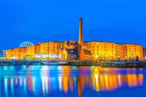 a large building next to a body of water at Urban and stylish Central Studio Apartment in Liverpool with high speed free wifi in Liverpool