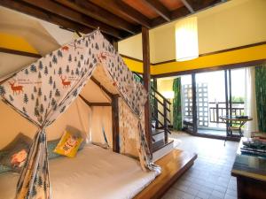 a bedroom with a bed with a tent in it at Yoho Beach Resort Kenting in Hengchun South Gate
