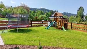 a backyard with a playground and a play structure at Chalupa U Juráša in Horní Bečva