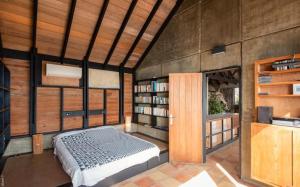 a bedroom with a bed and a book shelf at Saint Barth Villa 8 in Pointe Milou