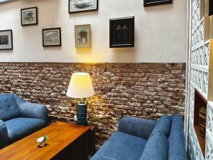 a living room with two blue couches and a table at Betel Nut Lodge in George Town