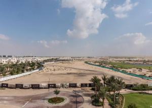 an aerial view of a beach and a city at StoneTree - Furnished 1BR in Peaceful Community in Dubai