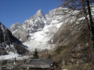 a snow covered mountain with a building in front of it at Chalet Chamois in Courmayeur