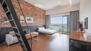 a living room with a brick wall at Lucid M in Seogwipo