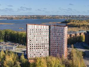 an overhead view of a tall building with a river at Noli Otaniemi in Espoo
